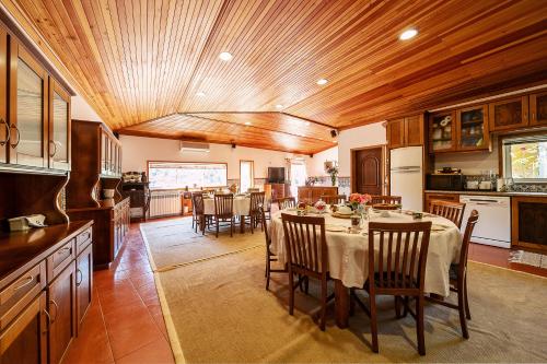 a kitchen and dining room with a table and chairs at Refúgio entre o Pomar e o Rio Douro in Raiva
