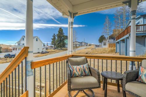 a porch with two chairs and a table at 109 W Golden in Cripple Creek