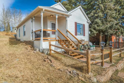 a white house with a porch and a wooden fence at 109 W Golden in Cripple Creek