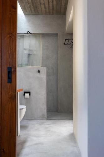 a bathroom with a toilet and a sink at Ammoo in Amoopi