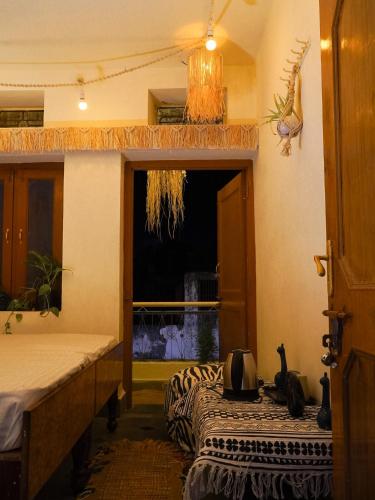 a room with two beds and a window at Bohosthal guest house in Pushkar