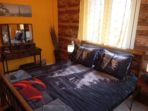 a bedroom with a bed with a red backpack on it at DREAM Home Ioannina in Ioannina