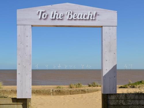 a sign on the beach with the words to the beach at Dune Cottage in Caister-on-Sea