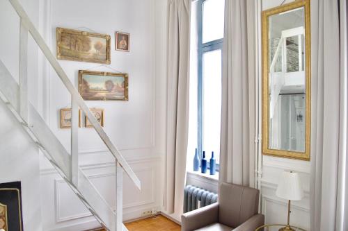 a white staircase in a room with a window at Guesthouse Marie Therese in Brussels