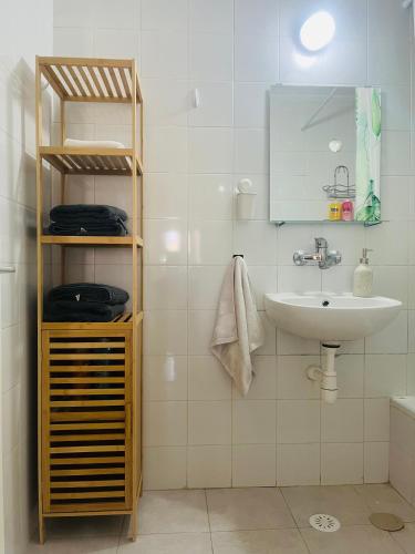 a white bathroom with a sink and a mirror at Camel Peak View in Mitzpe Ramon