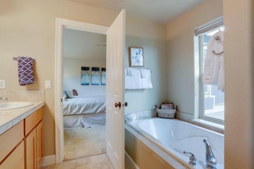 a bathroom with a bath tub and a bedroom at Aspen Ridge in Bend