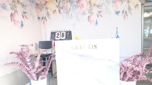 a store with a clock and flowers on the wall at Wings Alley Phuket in Phuket