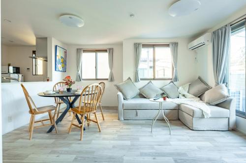 a living room with a couch and a table at Skytree House Oshiage New 3-story Villa, 2 Showers, 2 Toilets, 4 Rooms, 3 min walk to Oshiage Station in Tokyo