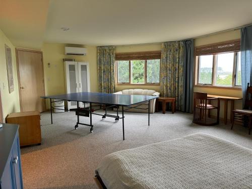 a room with a ping pong table in it at Family Vacation Home - Stunning Views across Salt Pond in Bethany Beach
