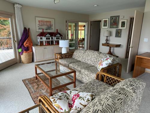 a living room with a couch and a table at Family Vacation Home - Stunning Views across Salt Pond in Bethany Beach