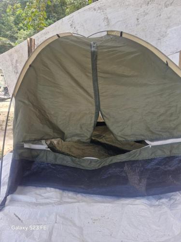 a tent with the door open on top of it at Camping - Recanto do Leâo in Guarujá
