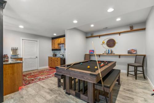 a living room with a pool table and a kitchen at 1144 Equinox in Colorado Springs