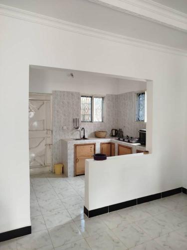 a kitchen with a white counter in a room at Fun Haribo B&B Apartment in Uroa