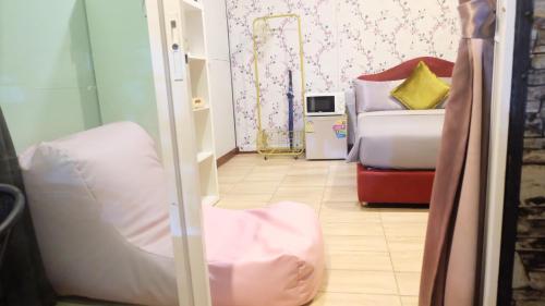 a hotel room with a bed and a mirror at Wings Alley Phuket in Phuket