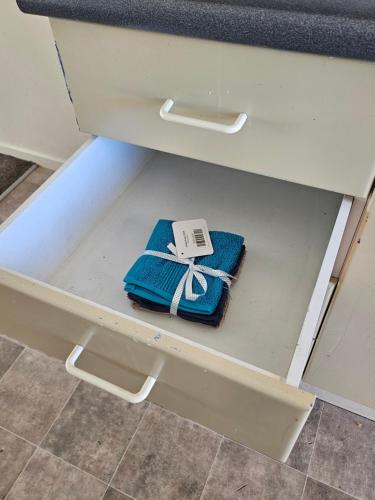 a drawer with a phone sitting on top of it at Chriatcurrch Best Home in Christchurch