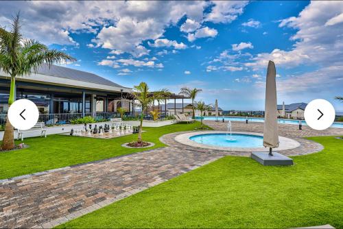 a view of a resort with a pool and a statue at 832 Villa in Ballito