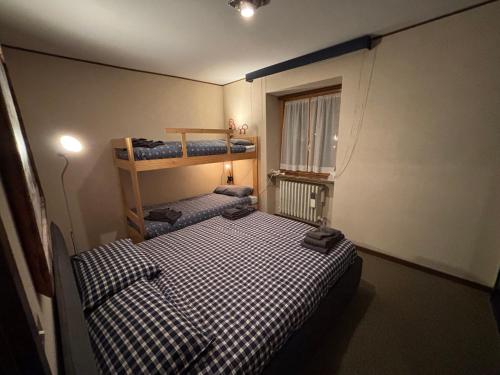 a room with two bunk beds and a window at mountain summit sestriere in Sestriere