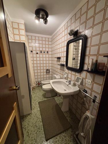a bathroom with a sink and a toilet and a mirror at mountain summit sestriere in Sestriere