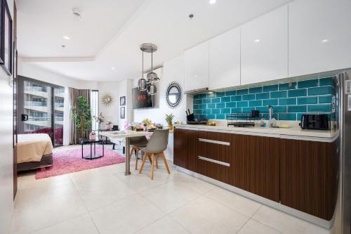 a kitchen and living room with a table and chairs at Dominiks pink dream Studio Balcony Ocean View Balcony Fast-Wifi at Tambuli Resort High Floor in Maribago