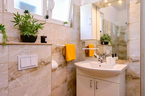 a bathroom with a sink and a mirror at Holiday Villa Noa in Orebić