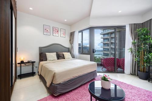 a bedroom with a large bed with a pink rug at Dominiks pink dream Studio Balcony Ocean View Balcony Fast-Wifi at Tambuli Resort High Floor in Maribago