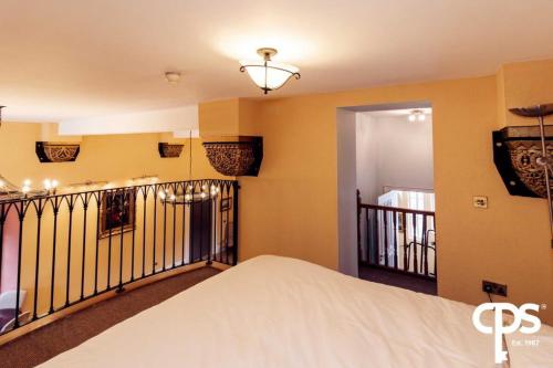 a room with a bed and a balcony at Bastian Gate Gosford Castle 