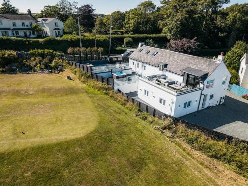 an aerial view of a house with a boat in it at Stunning Abersoch Cottage by golf course & beach in Abersoch