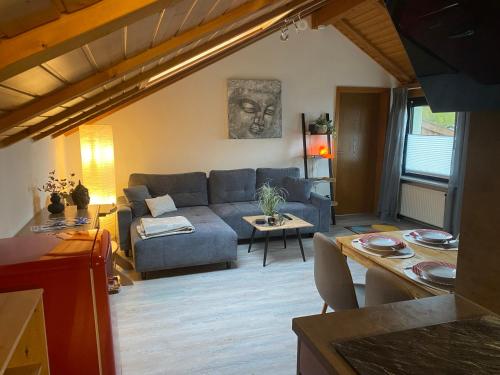 a living room with a couch and a table at Ferienwohnung Fischer in Rödental in Rödental