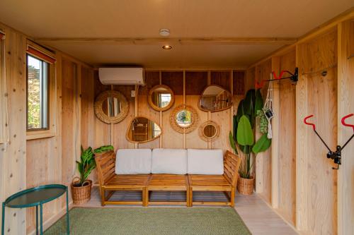 a room with a bench in a wooden wall at MIRISE Sky Villa & Sauna in Minakami