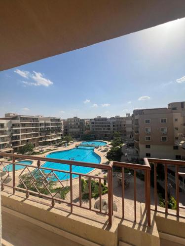 a view of a swimming pool from a balcony at Pearl pyramids Suites in Ghaţāţī