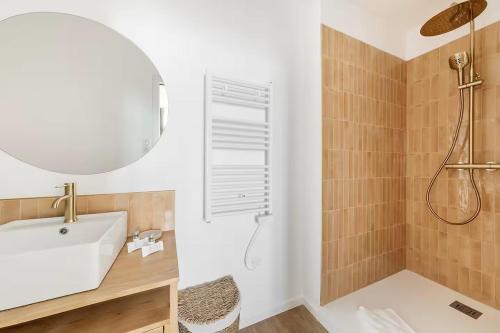 a bathroom with a tub and a sink and a shower at Bord de l'Eau 4 in Cancale