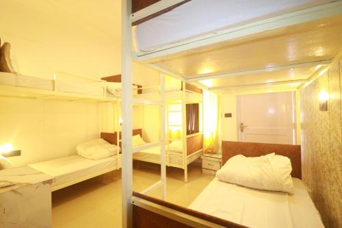 a room with two bunk beds and a mirror at Shaanti Coliving in Rishīkesh