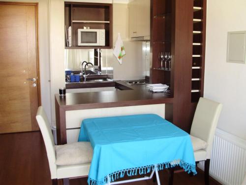 a kitchen with a table with a blue table cloth on it at Departamento acogedor con excelente ubicación in El Cerrillo