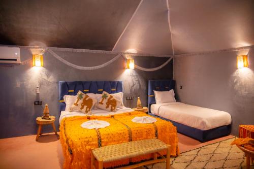 a bedroom with two beds in a room at Luxury Desert Tents - Agafay Experience in Aït Mazou