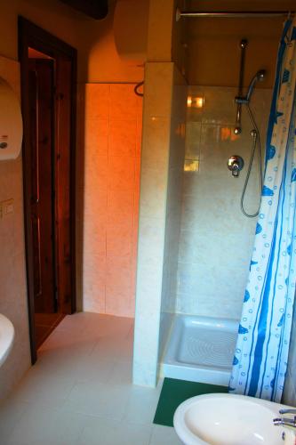 a bathroom with a shower and a sink and a tub at Feudo di Villa Anticaglia in Briatico