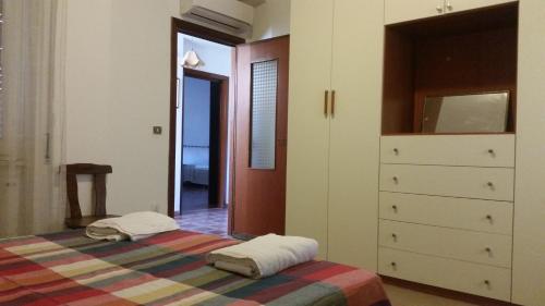 a bedroom with a bed and a dresser at Appartamento Alemù in Olbia