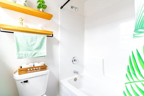 a bathroom with a toilet and a sink and a tub at Prime Location Top Rated Clean Parking Free! in Chillicothe