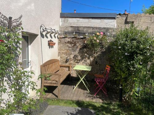 a patio with two chairs and a table in a garden at Maison indépendante cosy avec terrasse privée - La Laiterie in Nantes