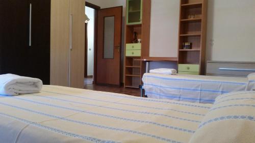 a bedroom with two beds with towels on them at Appartamento Alemù in Olbia