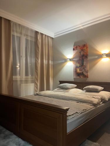 a bedroom with a large bed with two pillows at Apartament Prestige Zawiercie in Zawiercie