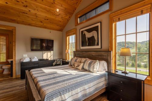 a bedroom with a bed with a horse picture on the wall at Valley View in Banner Elk