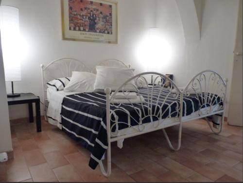 a bedroom with a bed with a black and white comforter at Comfy in the Heart of Roman nightlife in Rome