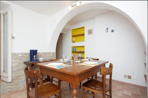 a dining room with a wooden table and chairs at Comfy in the Heart of Roman nightlife in Rome