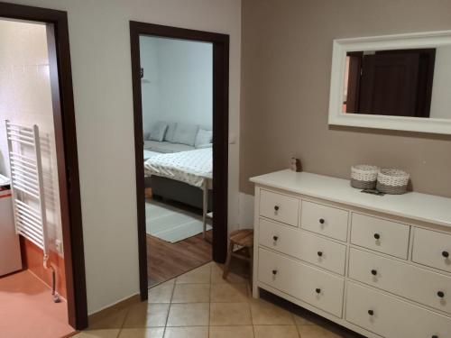 a bedroom with a mirror and a dresser and a bed at Apartmán Viktória 5 in Ružomberok