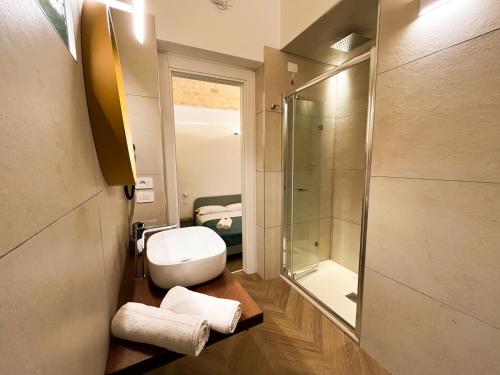 a bathroom with a toilet and a glass shower at Residenza Veneto 80 in Vasto