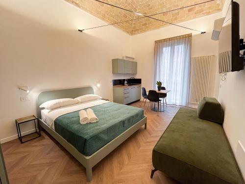 a bedroom with a bed and a dining room at Residenza Veneto 80 in Vasto