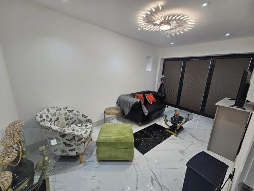 a living room with a couch and a chair at Heaven in Sutton