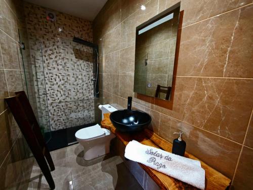 a bathroom with a sink and a toilet and a mirror at Casa na Serra da Estrela - Solar do Prazo in Gonçalo