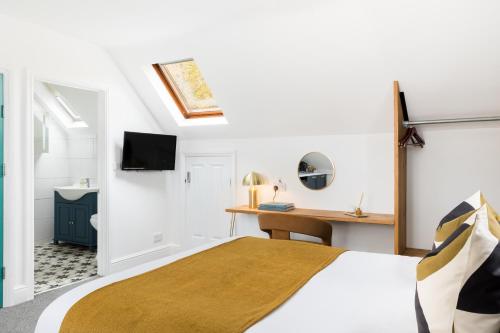 a bedroom with a bed and a desk at The Adelphi Aparthotel in Stratford-upon-Avon