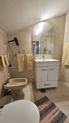 a bathroom with a sink and a toilet and a mirror at Suite Porto in Porto